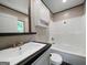 Bright bathroom featuring a vanity, mirror, toilet, and shower-tub combo at 273 Ridge Dr, Villa Rica, GA 30180