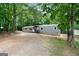 Exterior view of home with gray siding and wooded surroundings at 273 Ridge Dr, Villa Rica, GA 30180