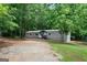 Home exterior surrounded by mature trees and a natural landscape at 273 Ridge Dr, Villa Rica, GA 30180