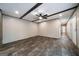 Open living room with luxury vinyl floors, beams on ceiling, and neutral wall color at 273 Ridge Dr, Villa Rica, GA 30180