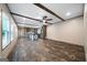 Open living room features luxury vinyl floors, ceiling beams, and access to the kitchen area at 273 Ridge Dr, Villa Rica, GA 30180