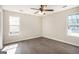 Bedroom with two windows providing natural light and a ceiling fan for comfort at 5575 Pine Gate Dr, Atlanta, GA 30349