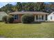 Charming single-story brick home with a well-maintained lawn and mature landscaping at 5575 Pine Gate Dr, Atlanta, GA 30349