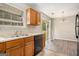Bright kitchen with stainless steel sink, wooden cabinets, and sliding glass doors to the backyard at 5575 Pine Gate Dr, Atlanta, GA 30349