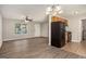 Bright living room open to kitchen, featuring hardwood floors, ceiling fan, and updated appliances at 5575 Pine Gate Dr, Atlanta, GA 30349