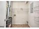 Utility room featuring a furnace, storage shelving, and a tiled floor at 5575 Pine Gate Dr, Atlanta, GA 30349