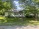 Charming one-story home with lush trees and a well-manicured lawn, offering great curb appeal at 4109 Francis Ne St, Covington, GA 30014