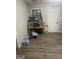 Kitchen area features wood laminate flooring and is filled with household items and boxes at 4109 Francis Ne St, Covington, GA 30014