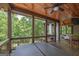 Back porch features a hot tub, seating, privacy curtains, and wooded scenery at 177 Selfridge Rd, Mcdonough, GA 30252