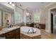 Elegant bathroom with soaking tub, dual vanities, granite counters, and tiled floors at 177 Selfridge Rd, Mcdonough, GA 30252
