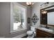 Well-lit bathroom with granite countertops, decorative lighting, and a view to the outdoors at 177 Selfridge Rd, Mcdonough, GA 30252