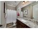 Bright bathroom with granite countertops, decorative art, wood look floors, and white shower curtain at 177 Selfridge Rd, Mcdonough, GA 30252
