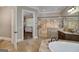 Elegant bathroom featuring a walk-in shower with glass door and a soaking tub with stylish fixtures at 177 Selfridge Rd, Mcdonough, GA 30252