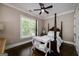 Cozy bedroom features a four poster bed, dark hardwood floors and plenty of natural light from the window at 177 Selfridge Rd, Mcdonough, GA 30252