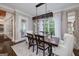 Formal dining room features a rustic table with an industrial light fixture and large window at 177 Selfridge Rd, Mcdonough, GA 30252