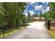 Gated driveway and mature trees offer privacy and seclusion for this home in a wooded setting at 177 Selfridge Rd, Mcdonough, GA 30252