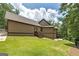 Exterior view of a home with green lawn, featuring siding, stairs, and elevated back porch at 177 Selfridge Rd, Mcdonough, GA 30252