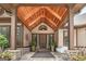 Inviting front entrance with a wood ceiling, a decorative sitting swing, and detailed stone pillars at 177 Selfridge Rd, Mcdonough, GA 30252