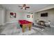 Spacious game room featuring a pool table, ceiling fan, zebra rug, and comfortable seating at 177 Selfridge Rd, Mcdonough, GA 30252