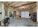 Spacious garage area with unfinished walls, a garage door, and work equipment at 177 Selfridge Rd, Mcdonough, GA 30252