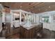 Gourmet kitchen flows into the living room with a large center island with pendant lighting above at 177 Selfridge Rd, Mcdonough, GA 30252