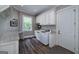 Well-lit laundry room with granite countertops, washer, dryer, sink, window and ample cabinet space at 177 Selfridge Rd, Mcdonough, GA 30252
