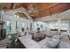 Open concept living room with a wooden ceiling, stone fireplace, and view of the eat-in kitchen at 177 Selfridge Rd, Mcdonough, GA 30252
