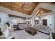 Bright and airy living room seamlessly connects to a modern kitchen with a wooden ceiling for a luxurious feel at 177 Selfridge Rd, Mcdonough, GA 30252