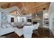 Elegant living room with a stone fireplace, wooden ceiling, and a large sectional sofa at 177 Selfridge Rd, Mcdonough, GA 30252