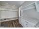 Well-organized mud room with built-in storage, granite countertops and wood look floors at 177 Selfridge Rd, Mcdonough, GA 30252