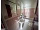 Vintage bathroom with pink tile, a pedestal sink, and a shower-tub combination, offering classic charm at 1511 Walker Ave, Atlanta, GA 30337