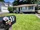 Inviting single-story home with a manicured lawn and charming mailbox, nestled in a serene neighborhood at 1511 Walker Ave, Atlanta, GA 30337