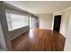 Bright living room with hardwood floors, large windows, and a freshly painted front door at 1511 Walker Ave, Atlanta, GA 30337