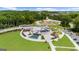 Stunning aerial shot featuring a vibrant community park with amphitheater, walking paths, and water features at 397 Cypher Dr, Suwanee, GA 30024
