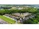 Scenic aerial view of a neighborhood with lush green trees, well-maintained homes, and community amenities at 397 Cypher Dr, Suwanee, GA 30024