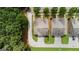 Aerial view of townhomes with driveways, manicured lawn, and surrounded by lush trees at 397 Cypher Dr, Suwanee, GA 30024