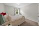Cozy bedroom with a floral patterned bedspread, plush pillows and carpet at 397 Cypher Dr, Suwanee, GA 30024