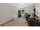 Bright bedroom featuring neutral carpet, a window view, built-in bookcase and a desk at 397 Cypher Dr, Suwanee, GA 30024
