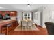 Well-lit dining area adjacent to the kitchen featuring hardwood floors and a built-in china cabinet at 397 Cypher Dr, Suwanee, GA 30024