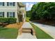 Inviting entryway with walkway to front door of home surrounded by trimmed shrubs and a well-maintained lawn at 397 Cypher Dr, Suwanee, GA 30024