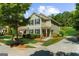 Charming two-story home features a well-manicured lawn, complemented by lush trees and beautiful landscaping at 397 Cypher Dr, Suwanee, GA 30024