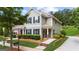 Charming home featuring well-manicured lawn, shutters, and a walkway to a red front door at 397 Cypher Dr, Suwanee, GA 30024
