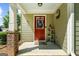 Charming front porch with a red door, decorated with seasonal wreaths and patriotic decorations at 397 Cypher Dr, Suwanee, GA 30024
