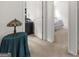 Hallway with carpet leading to a bedroom and visible side table with vintage lamp at 397 Cypher Dr, Suwanee, GA 30024