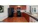 The efficient kitchen features stainless steel appliances, ample counter space, and a tiled backsplash at 397 Cypher Dr, Suwanee, GA 30024