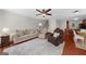 Cozy living room featuring plush seating, a ceiling fan, and an open layout, perfect for relaxing and entertaining at 397 Cypher Dr, Suwanee, GA 30024
