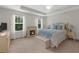 Main bedroom featuring fireplace, sitting area, ceiling fan, and two windows at 397 Cypher Dr, Suwanee, GA 30024