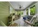 Enclosed porch with ceiling fan and many windows offering views of wooded property at 397 Cypher Dr, Suwanee, GA 30024