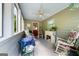 Enclosed porch with ceiling fan and many windows offering views of wooded property at 397 Cypher Dr, Suwanee, GA 30024