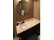 Bathroom vanity with a round mirror and cabinets at 905 Ohara Dr, Jonesboro, GA 30236